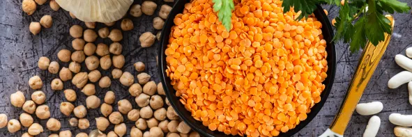Trio  lentilles corail, haricots blancs et pois chiches sur un plan de travail